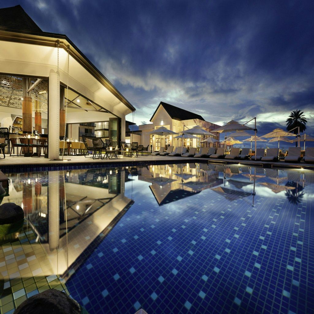 A resort pool lit up at night